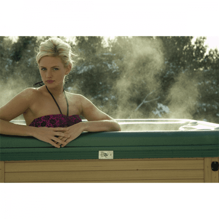 Woman posing in steaming hot tub, that is on display in showroom of Schererville spa store.